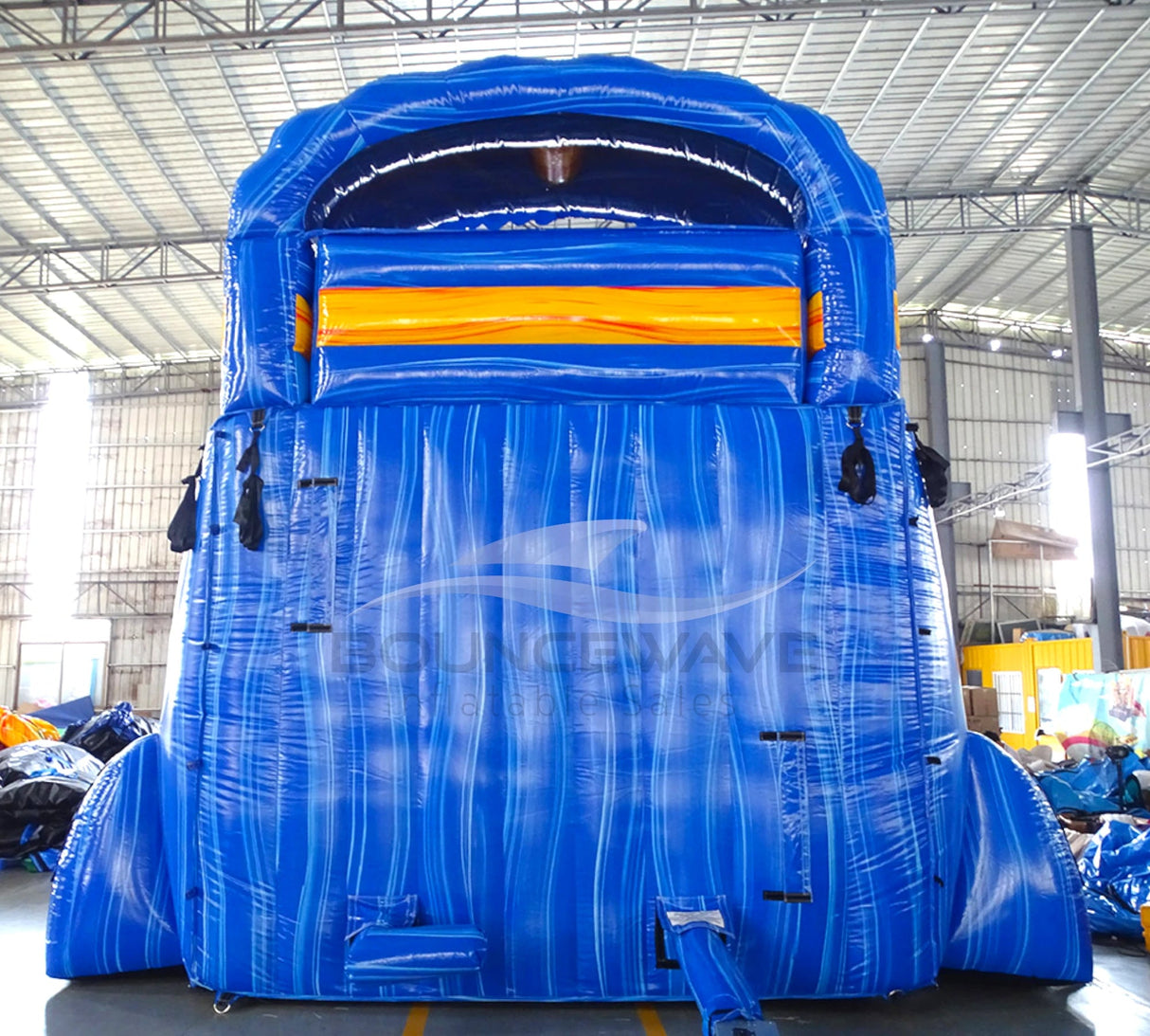 Rear view of Fire and Ice hybrid water slide, showcasing tall blue structure with climbing area and safety features.