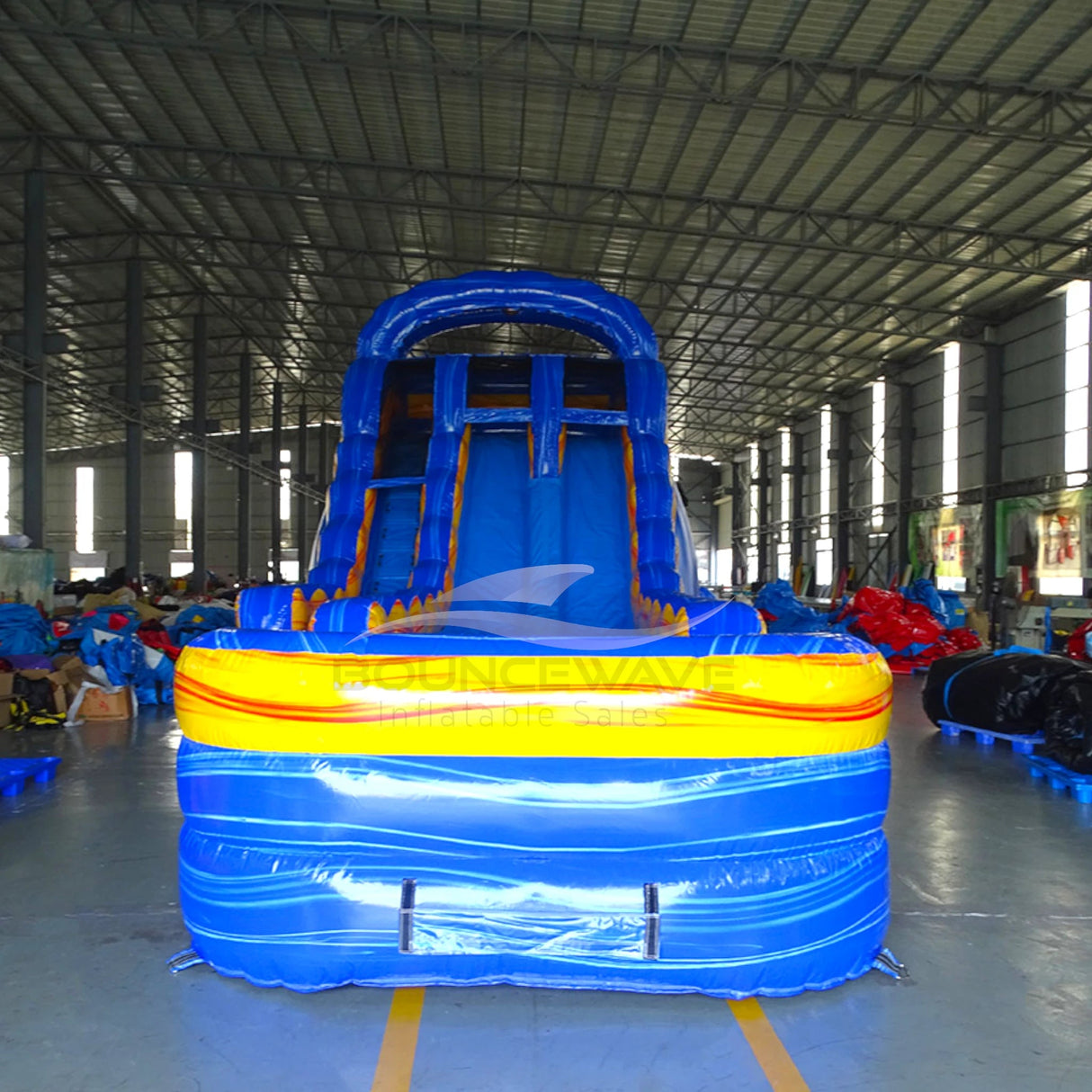 Close-up front view of Fire and Ice inflatable water slide, displaying vibrant blue base with orange and yellow accents and wave design.