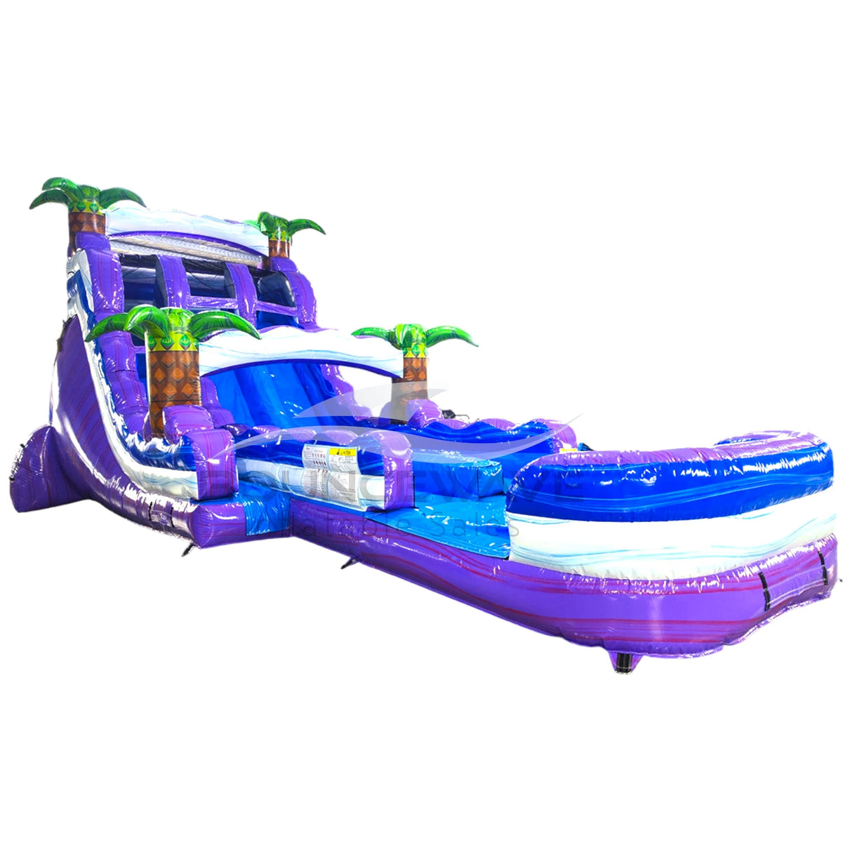 Large tropical-themed inflatable water slide featuring dual purple sliding lanes, palm tree decorations, and an extended splash pool with blue wave-like design.