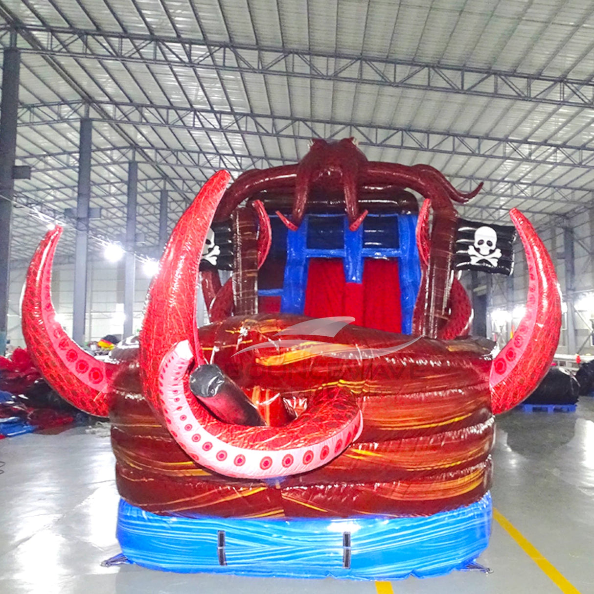 Front view of Tentacle Typhoon inflatable water slide displaying red octopus head, blue sliding lanes, brown ship base, and large tentacles wrapping around the structure.