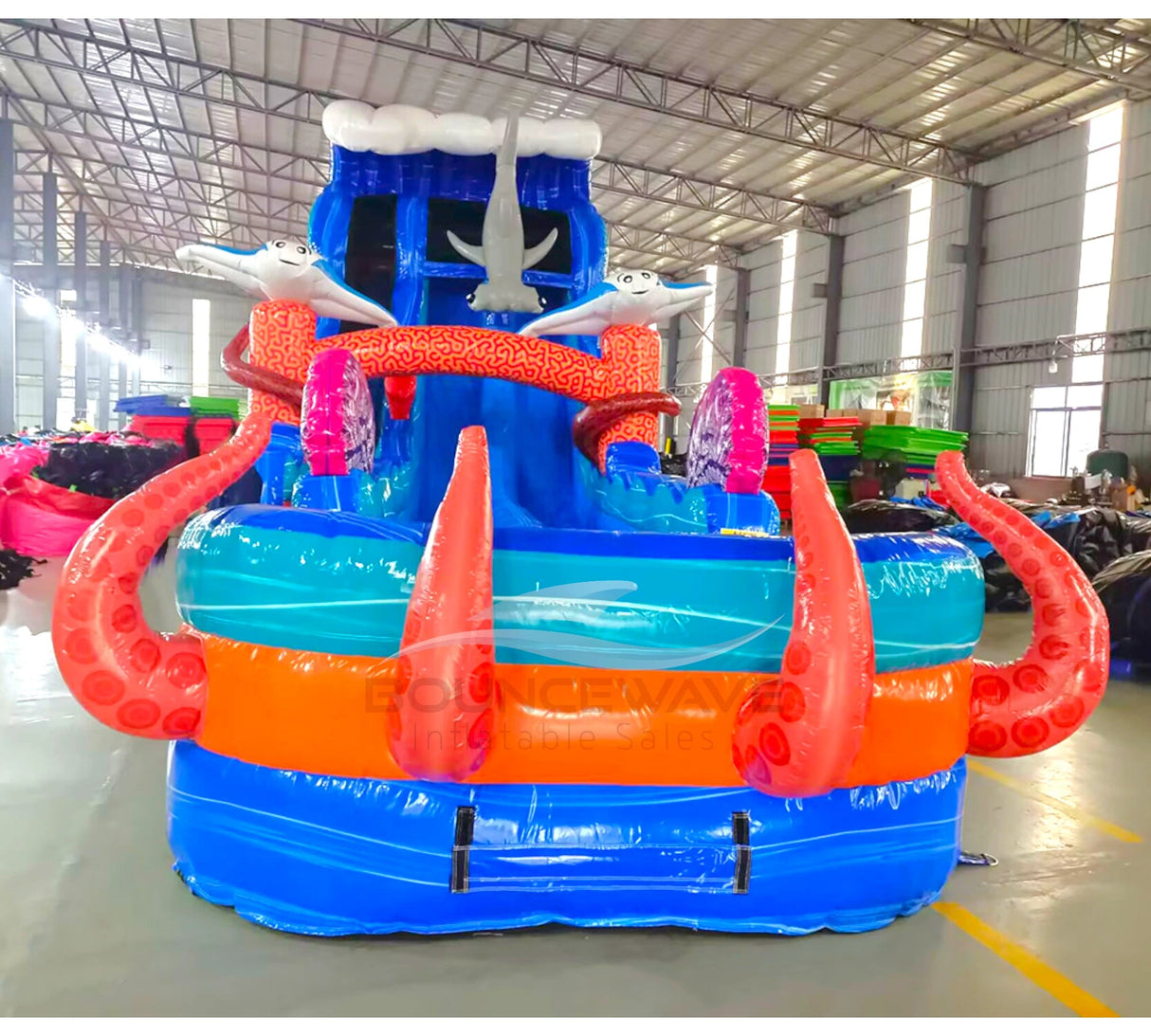Isolated view of 20ft Hammerhead Reef Hybrid DL water slide featuring blue color scheme, shark figures, octopus tentacles, and a large splash pool area. The slide is shown against a white background, highlighting its ocean theme and design elements.