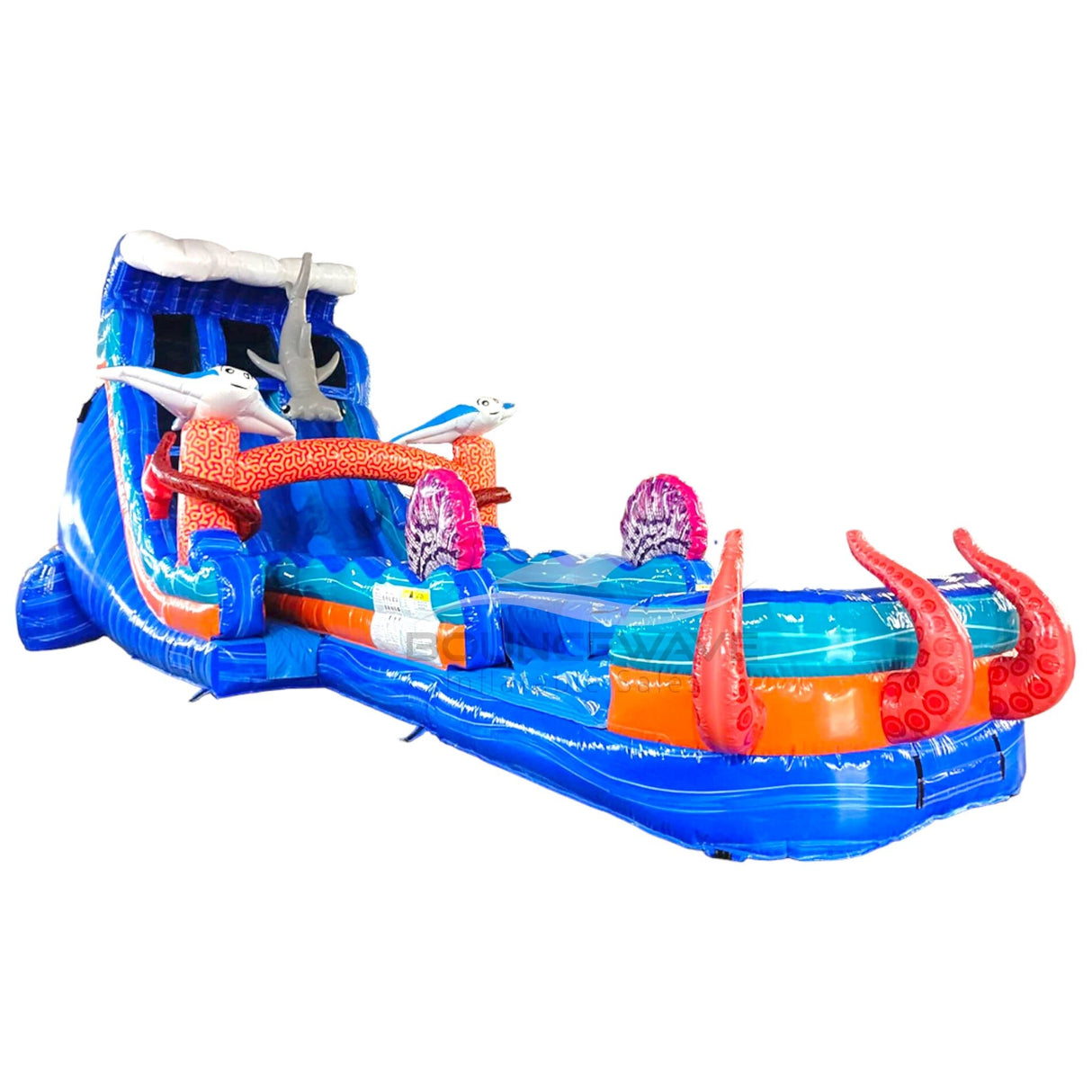 Front view of the 20ft Hammerhead Reef Hybrid DL inflatable water slide, showcasing its blue sliding lanes, shark decorations, octopus tentacles, and spacious splash pool with "BOUNCEWAVE" branding. The slide combines open and tube slide elements, set up in an indoor warehouse.