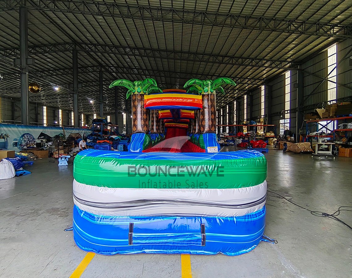 24ft Baja Splash DL 2pc Commercial Water Slide with Inflatable Slip & Slide front view displaying colorful design, palm tree decorations, and long blue slip and slide