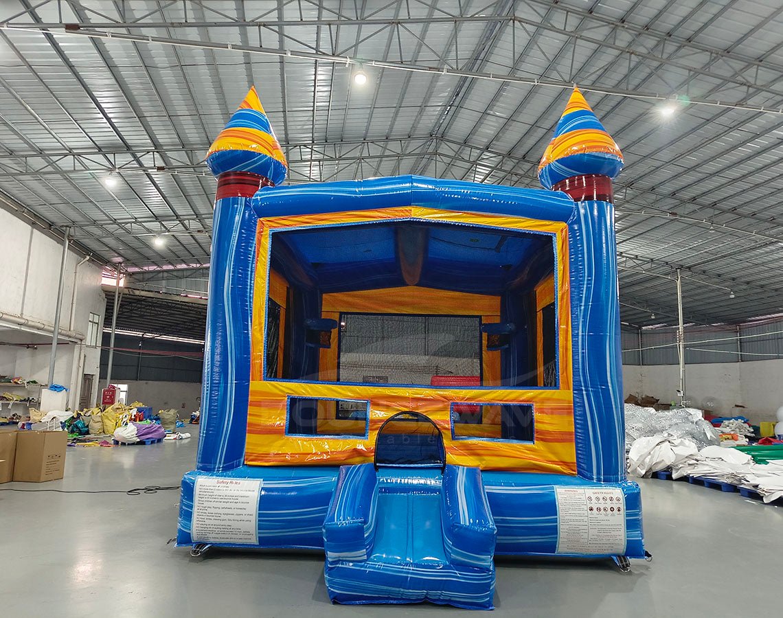 Fire and Ice Commercial Grade Bounce House in warehouse setting, showcasing blue and yellow design with spiral-topped towers