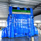 Rear view of dolphin-themed inflatable water slide, displaying tall blue structure and safety features.