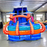 Front view of Hammerhead Reef hybrid water slide in indoor setting, showing tall structure with dual sliding lanes, shark figures, and colorful sea-life decorations.