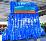Rear view of Hammerhead Reef inflatable water slide, displaying tall blue structure with shark silhouette and climbing area.