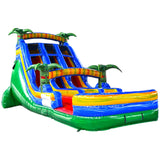 18ft-reggae-rush-center-climb-water-slide-349969.jpg: Large inflatable water slide with tropical theme, featuring blue sliding lanes, colorful palm tree decorations, tiki-style arches, and a vibrant splash pool area with red, yellow, and green accents.