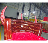 Large inflatable water slide featuring a giant red octopus design with tentacles, dual sliding lanes, brown pirate ship base, and extended splash pool area in indoor warehouse setting.