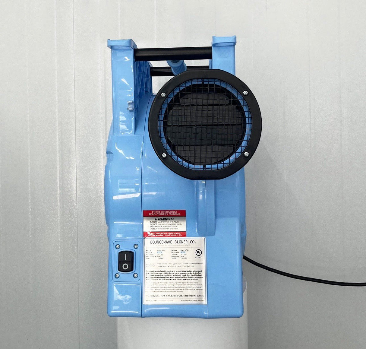3.0hp BounceWave Air Pump for Inflatables rear view highlighting light blue housing, air outlet, warning label, power switch, and product information sticker
