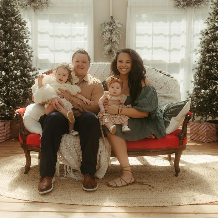 Blake Roberts, Assistant Sales Director, posing with a woman outdoors, both dressed formally against a scenic background with trees and gravel path