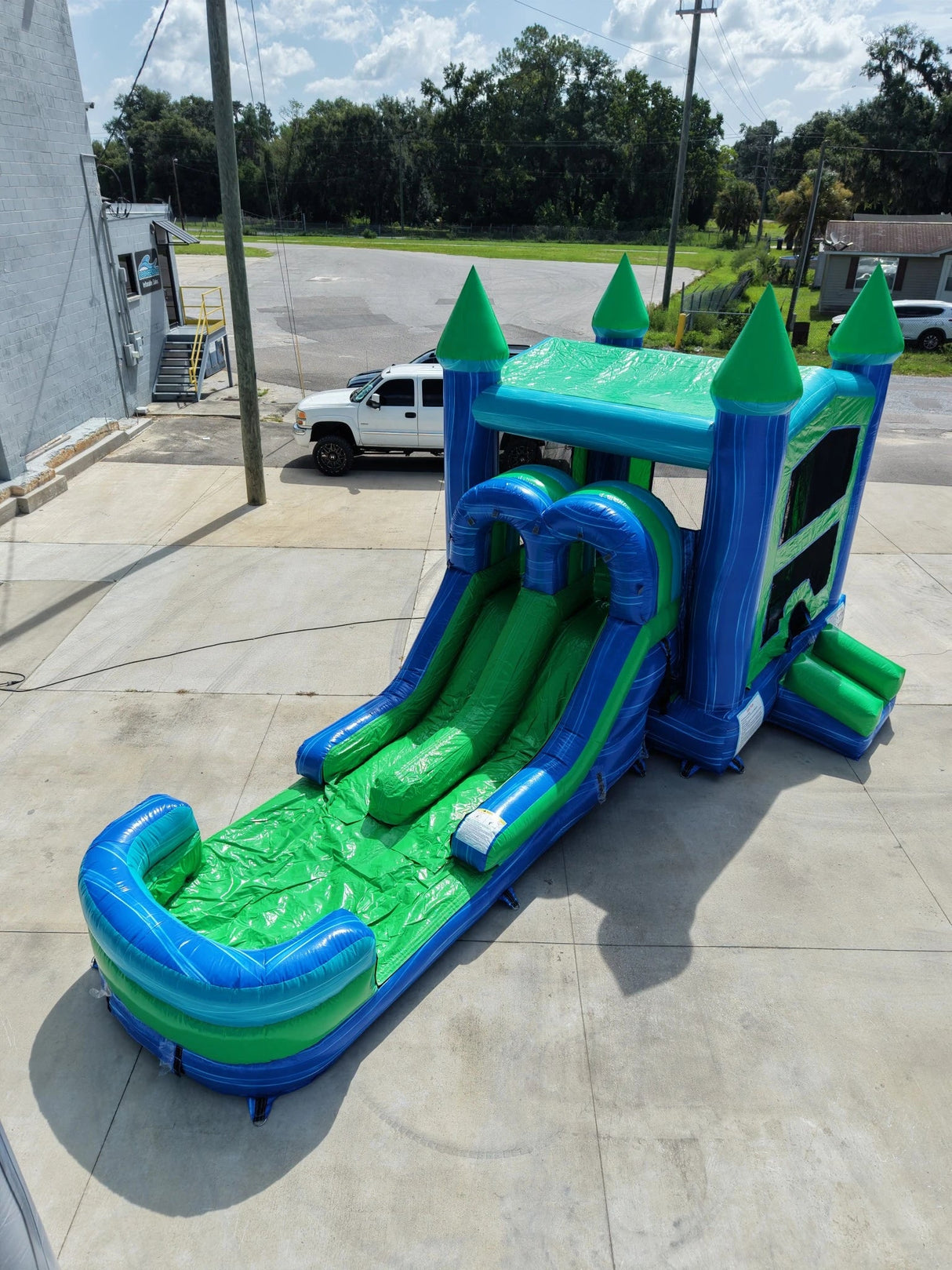 AquaBolt PowerPlay Dual Lane Bounce House with Slide Combo - BounceWave Inflatable Sales