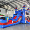 Large inflatable castle combo with bounce house, slide, and splash pool. Features blue and red colors with castle-like design elements. Set up in an indoor warehouse with metal roofing and other inflatable products visible in the background.