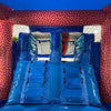 Interior view of Deep Sea Dive Dual Lane Commercial Inflatable Combo (Wet/Dry) showing dual blue slides with safety barriers. The inflatable features an underwater theme with pink and orange coral-like patterns on the walls. Part of the large orange octopus is visible at the top. Set up in a warehouse with metal roofing and support beams visible.