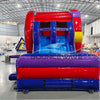 Front view of Ferris Wheel Dual Lane Commercial Inflatable Combo (Wet/Dry) set up in a large indoor facility. Features a red and blue inflatable structure with dual slides and a splash pool area. The "BOUNCEWAVE Inflatable Sales" logo is prominently displayed on the purple base. Other inflatable products and warehouse equipment visible in the background.