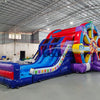 Wide-angle view of Ferris Wheel Dual Lane Commercial Inflatable Combo (Wet/Dry) in a spacious warehouse setting. Showcases the full structure including the Ferris wheel design, dual blue slides, and multicolored base. The warehouse interior is visible with metal roofing, walls, and other inflatable products in the background, providing scale and context for the combo's size.
