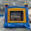 Fire and Ice Commercial Grade Bounce House interior view with yellow walls, mesh windows, and blue floor in warehouse environment
