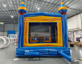 Fire and Ice Commercial Grade Bounce House interior view with yellow walls, mesh windows, and blue floor in warehouse environment
