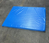 Impact Safety Mat for Inflatables displaying large blue padded surface with sewn edges on concrete floor
